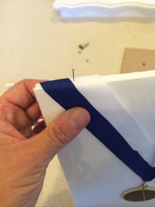 Pinning the neck drape to the top of the foam core.